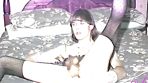 Busty brunette in stockings enjoys solo time in living room