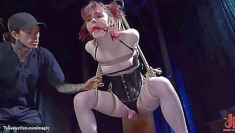 horny redhead is stuck on a rope and a gagging on it