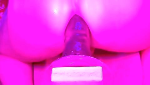 Beautiful blonde babe in a bikini enjoys playing with dildo