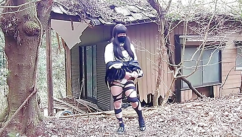 A sexy brunette in stockings in an abandoned house